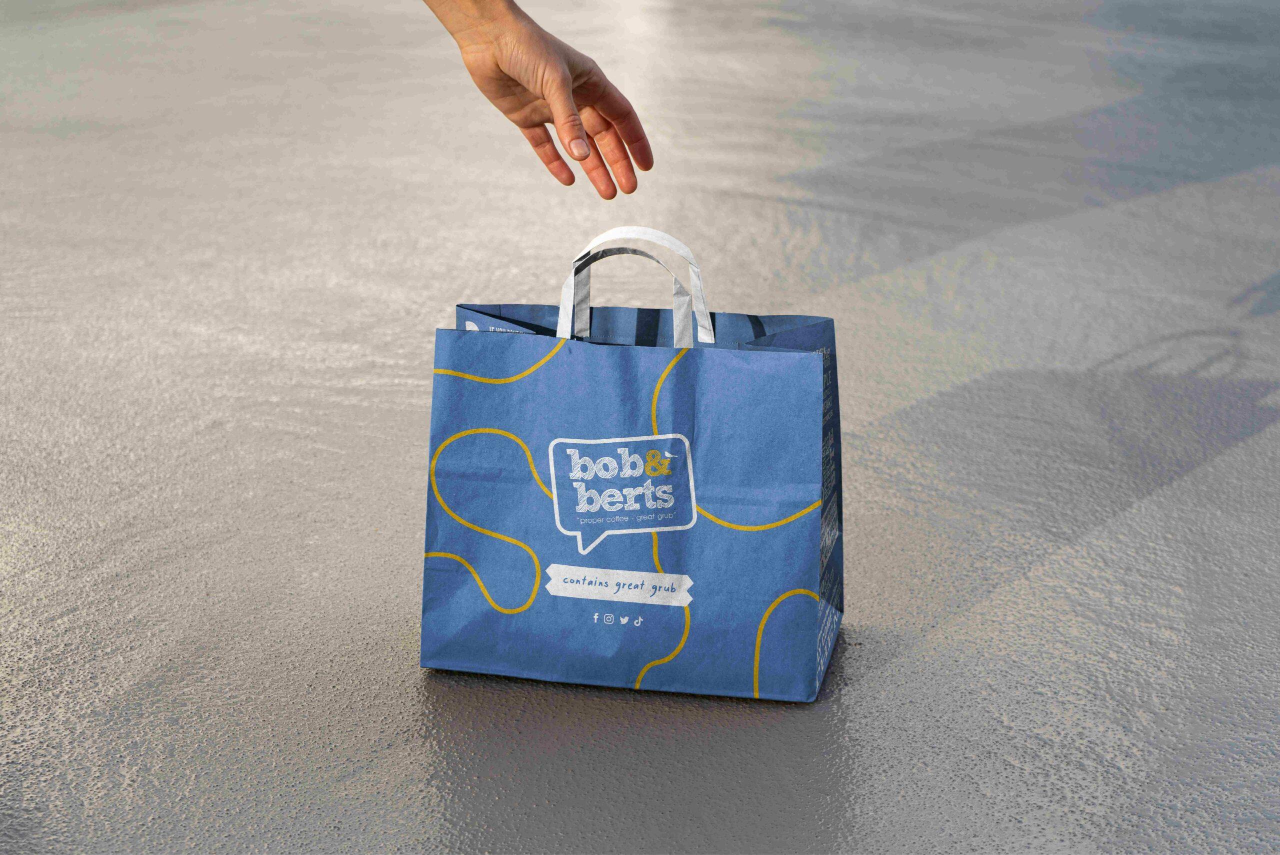 Blue and yellow takeaway bag packaging design for Bob & Berts by Rapid Agency
