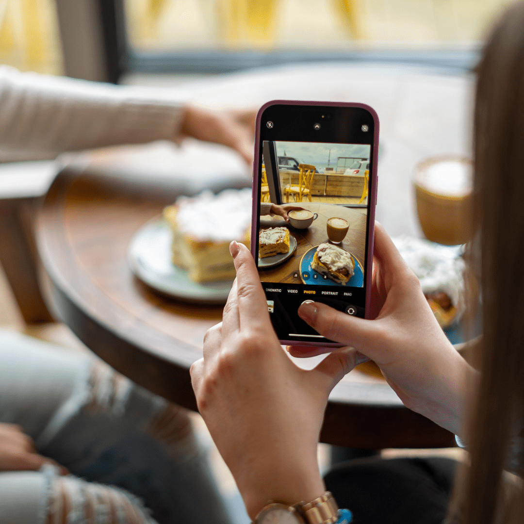 A mobile phone taking an image of cinnamon buns and coffees at Bob & Berts photographed by Rapid Agency